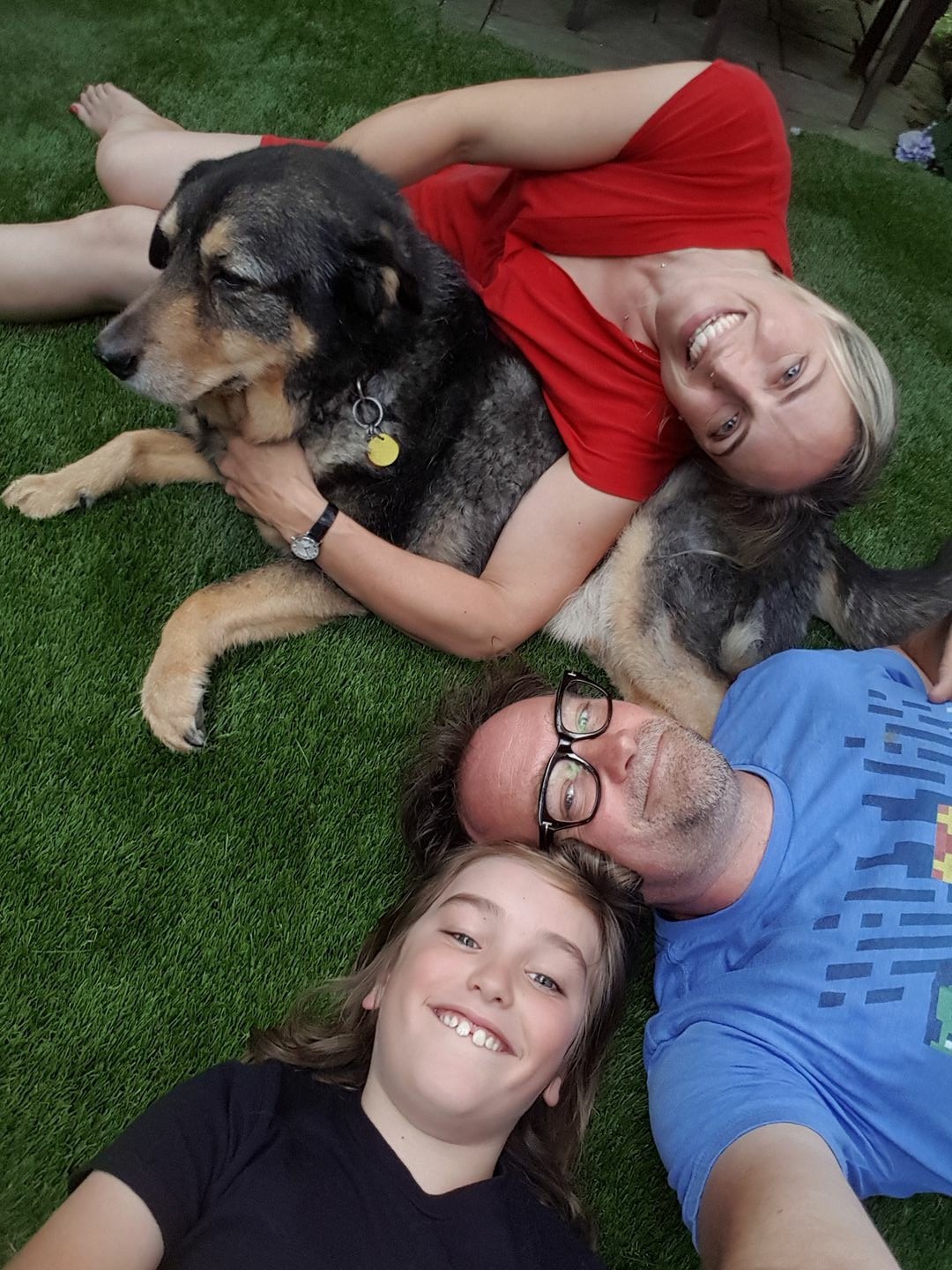 Happy family and dog on artificial grass